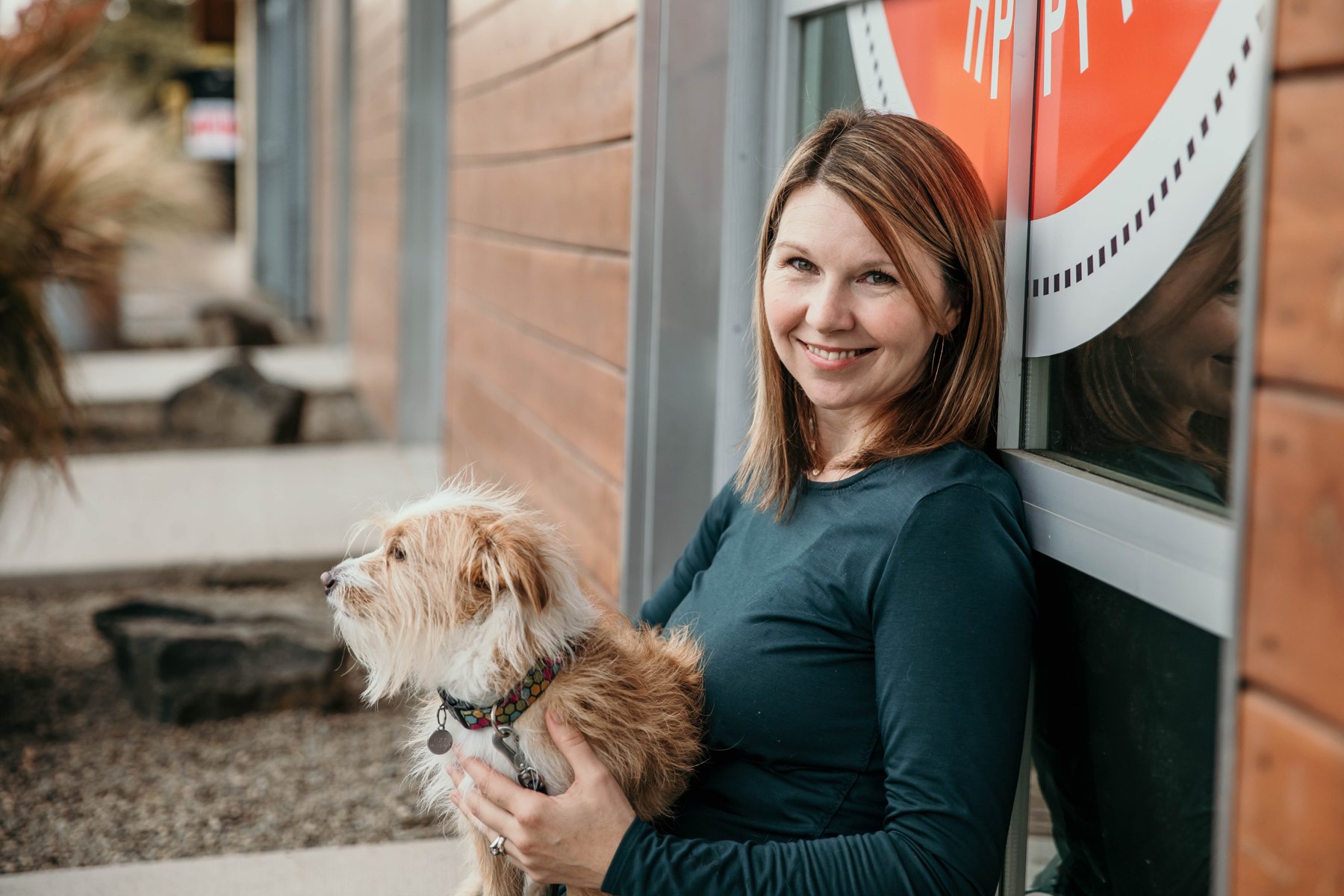 Tera holding a small terrier outside Training Spot